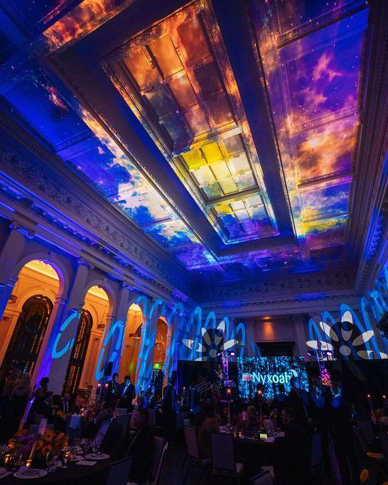 A private gala event produced by Convene Medical, dramatic ceiling projection over guests in an elegant ballroom