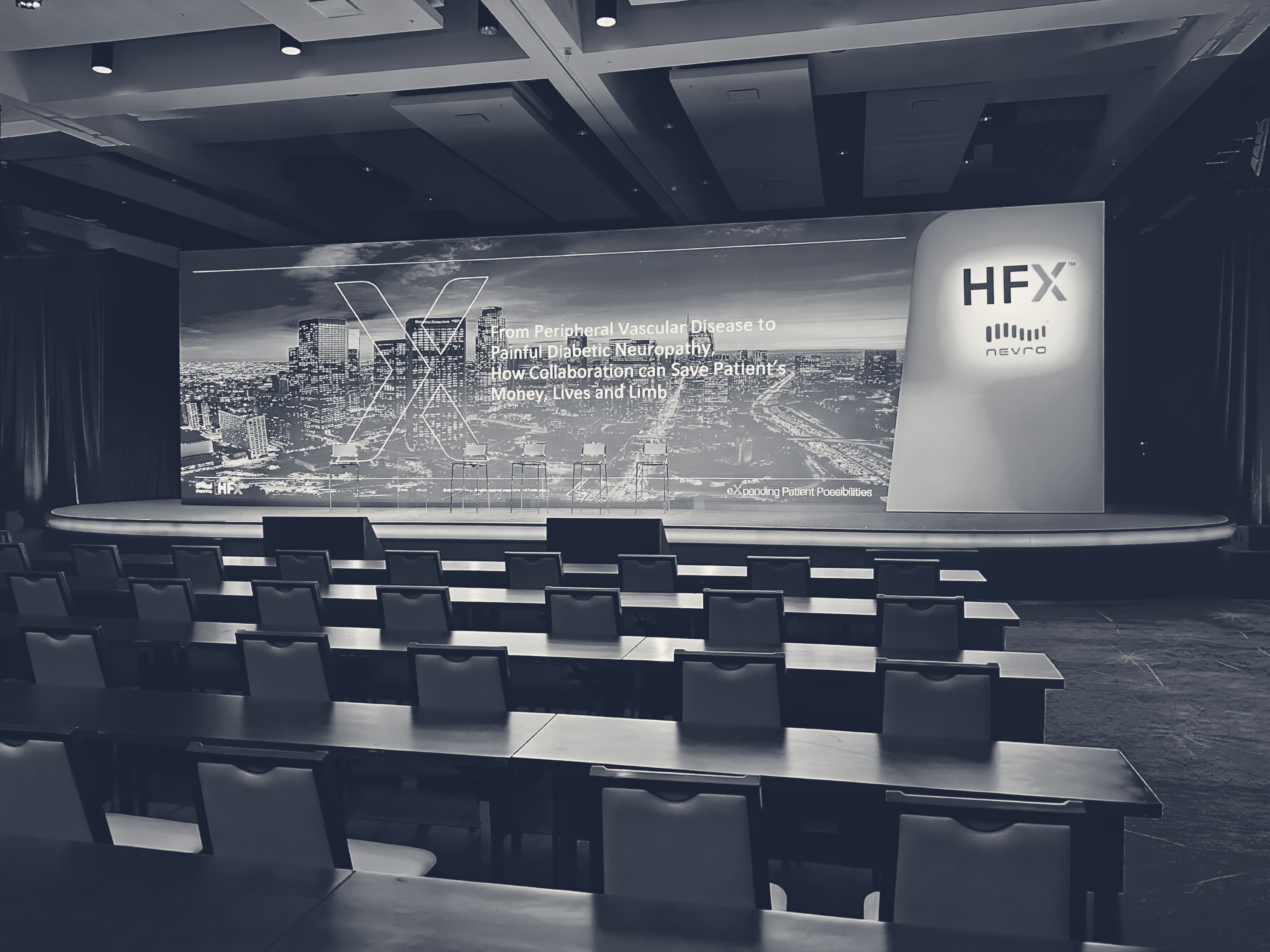 An empty stage set for a Convene Medical program, ready before the room fills
